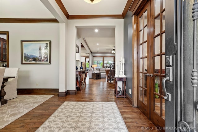 entryway with crown molding, baseboards, french doors, and wood finished floors