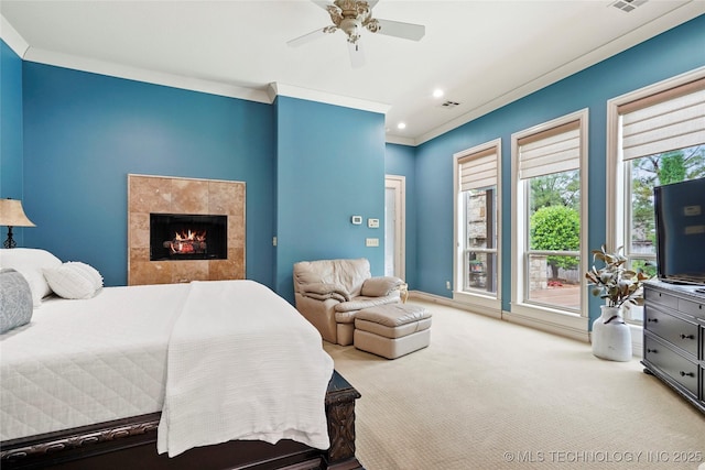 carpeted bedroom with ceiling fan, visible vents, crown molding, a fireplace, and recessed lighting
