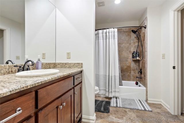 full bath with visible vents, vanity, toilet, baseboards, and shower / tub combo