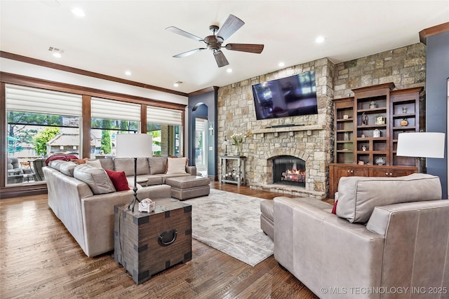 4401 S Quinoa Ave, Broken Arrow, OK 74011 - living room with ceiling fan, a stone fireplace, wood finished floors, recessed lighting, and crown molding