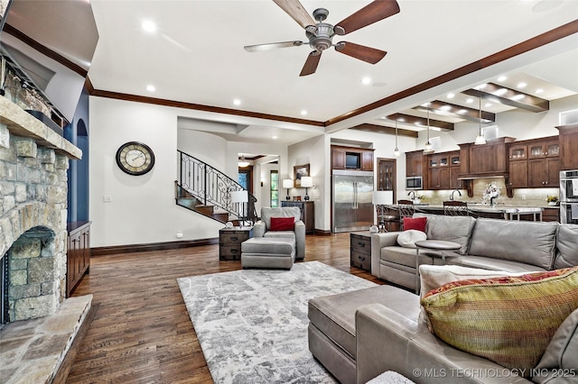 4401 S Quinoa Ave, Broken Arrow, OK 74011 - living room featuring a stone fireplace, a ceiling fan, stairs, recessed lighting, and dark wood-style flooring