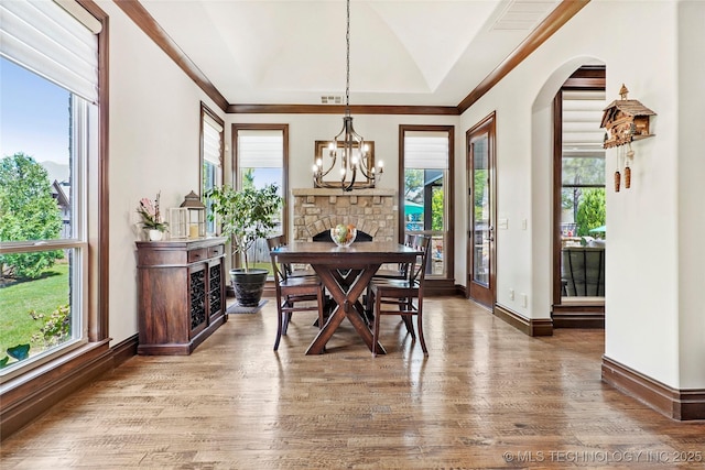 4401 S Quinoa Ave, Broken Arrow, OK 74011 - dining space featuring arched walkways, wood finished floors, and a chandelier