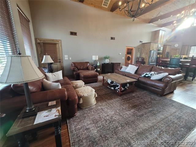 180 Channel Rd, Eufaula, OK 74432 - living room featuring high vaulted ceiling, a notable chandelier, wood finished floors, and visible vents