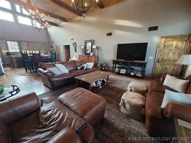 180 Channel Rd, Eufaula, OK 74432 - living room featuring visible vents, wood finished floors, high vaulted ceiling, beamed ceiling, and a chandelier