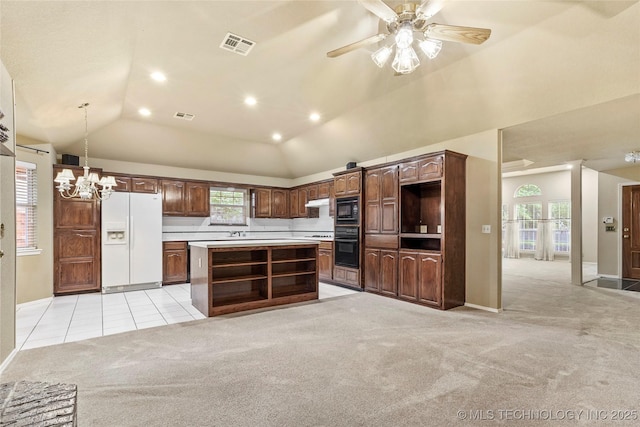 kitchen featuring visible vents, a center island, black appliances, light carpet, and recessed lighting