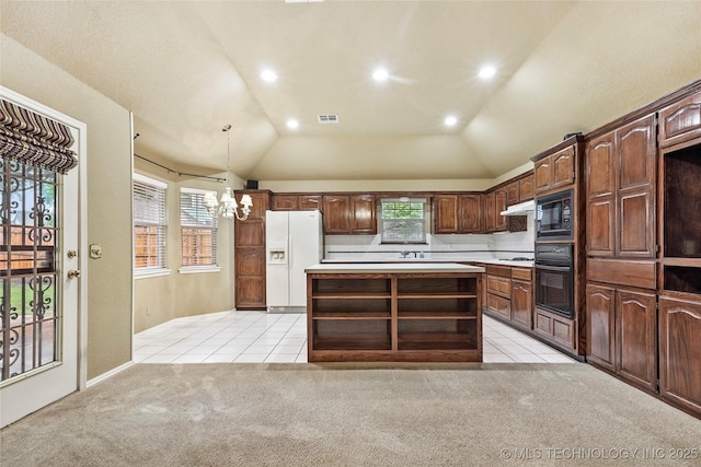 kitchen featuring light colored carpet, a notable chandelier, light tile patterned floors, and black appliances