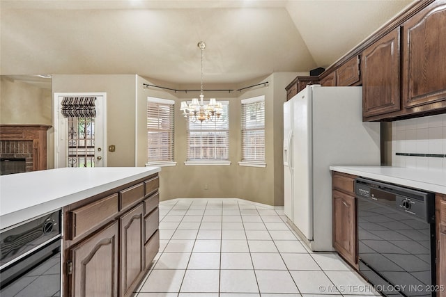 kitchen featuring plenty of natural light, light countertops, dishwasher, and a chandelier