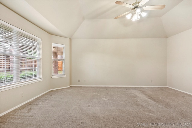 spare room with carpet, lofted ceiling, and a healthy amount of sunlight