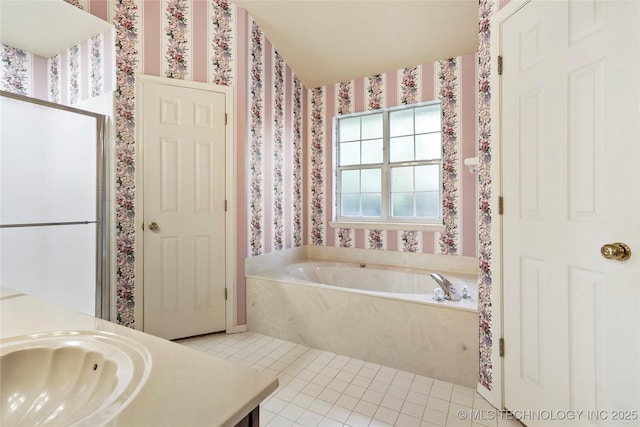 bathroom with a garden tub, a shower stall, vanity, tile patterned floors, and wallpapered walls