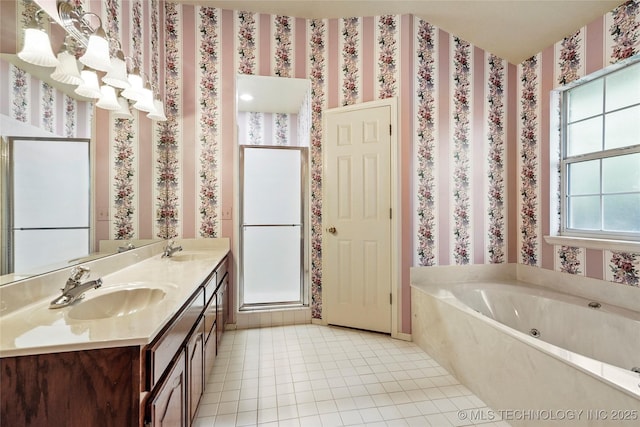 bathroom with tile patterned flooring, a sink, a bath, and a stall shower