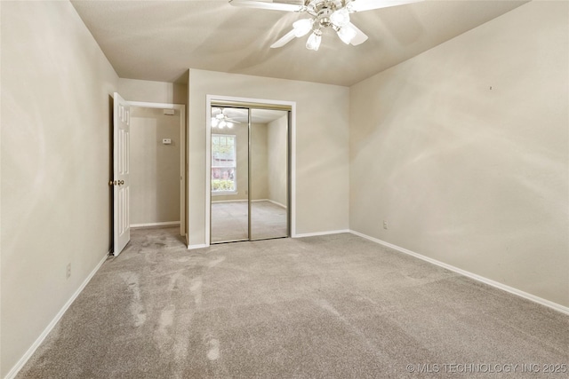 unfurnished bedroom featuring carpet floors, baseboards, a closet, and ceiling fan