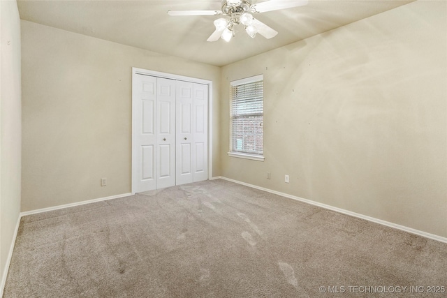 unfurnished bedroom featuring carpet floors, baseboards, and a closet
