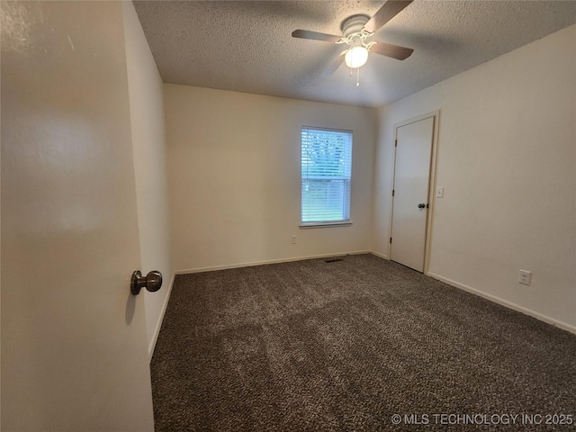 spare room featuring baseboards, a ceiling fan, a textured ceiling, and carpet flooring