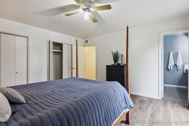 6727 S Richmond Ave Unit 632, Tulsa, OK 74136 - bedroom featuring wood finished floors, baseboards, multiple closets, and a ceiling fan