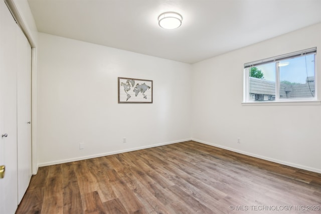 6727 S Richmond Ave Unit 632, Tulsa, OK 74136 - unfurnished bedroom featuring wood finished floors, baseboards, and a closet