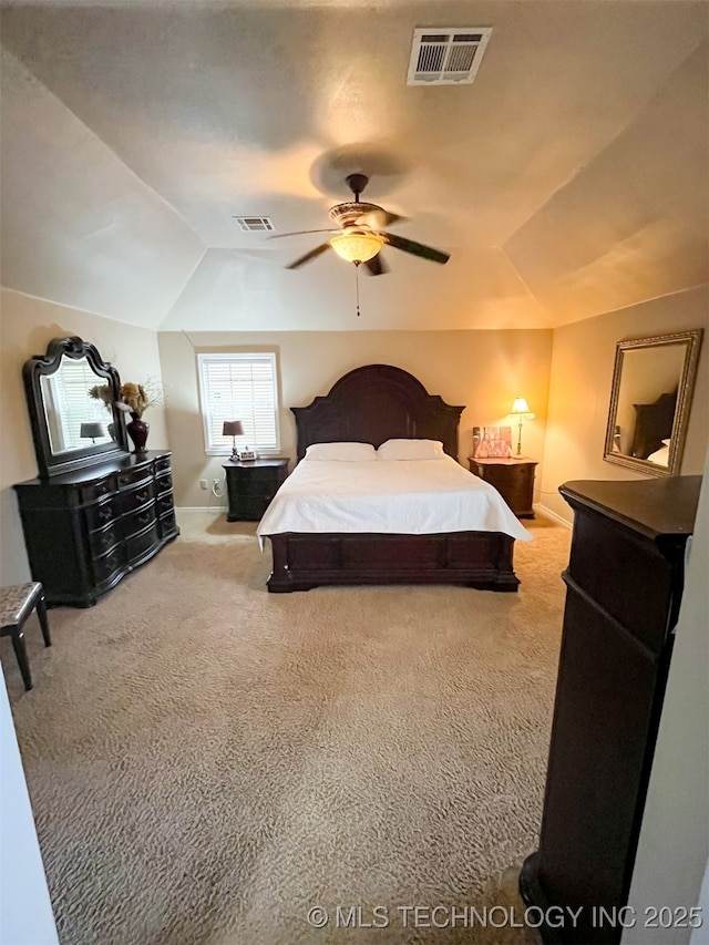 carpeted bedroom with visible vents, a ceiling fan, baseboards, and lofted ceiling