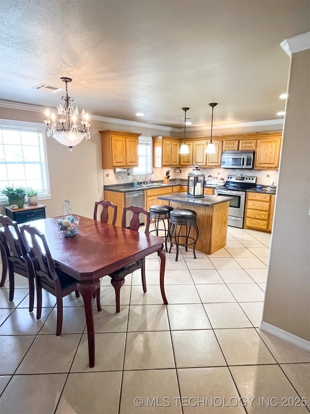 dining space with an inviting chandelier, ornamental molding, light tile patterned floors, and visible vents