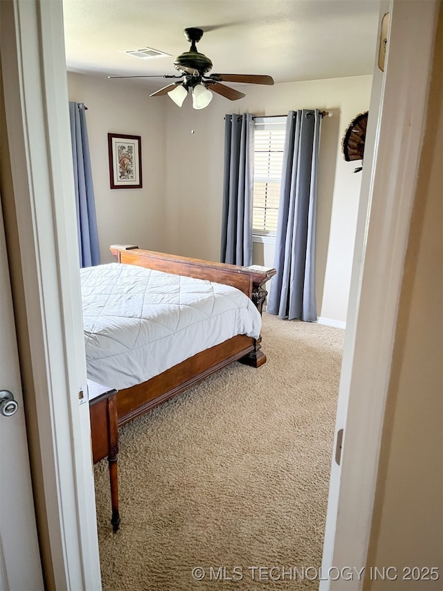 bedroom with carpet floors, baseboards, visible vents, and ceiling fan