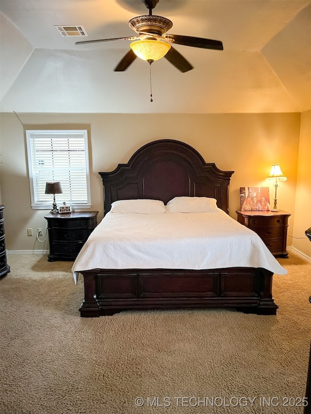 bedroom with visible vents, lofted ceiling, baseboards, a ceiling fan, and carpet