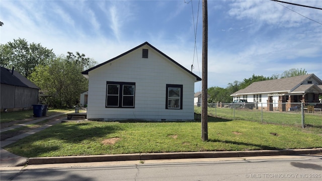 view of side of property featuring fence, a yard, and crawl space