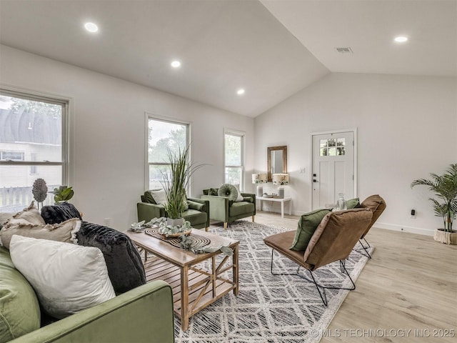 living room featuring lofted ceiling, recessed lighting, light wood-style flooring, and visible vents