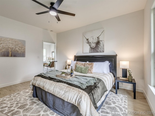bedroom featuring baseboards, a ceiling fan, and wood finished floors