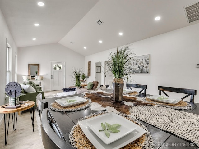 living area featuring recessed lighting, vaulted ceiling, light wood finished floors, and visible vents