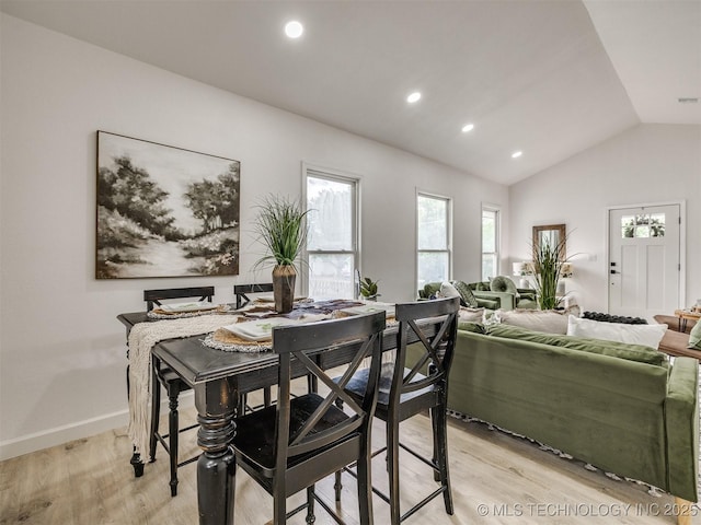 dining room featuring recessed lighting, baseboards, vaulted ceiling, and light wood-type flooring