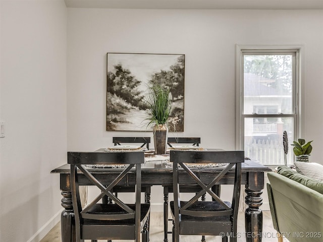 dining area featuring baseboards and wood finished floors