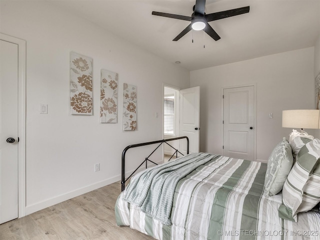 bedroom with baseboards, a ceiling fan, and light wood finished floors