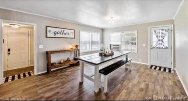 dining space with baseboards, ornamental molding, and wood finished floors