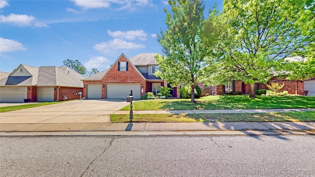 view of front of house with brick siding, a front lawn, an attached garage, and concrete driveway