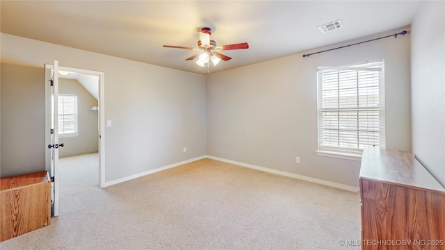 unfurnished room with baseboards, light carpet, a ceiling fan, and visible vents