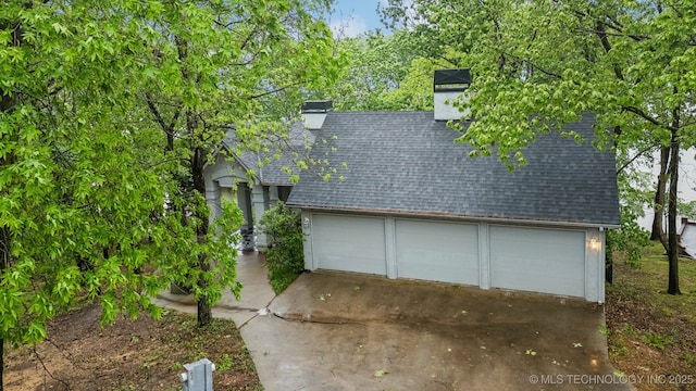 1491 Southpointe Rd, Eucha, OK 74342 - exterior space with a garage, a shingled roof, and a chimney