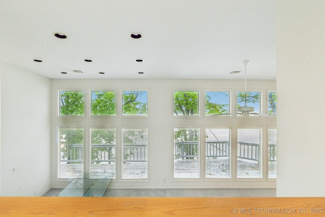 interior space featuring recessed lighting, visible vents, and a wealth of natural light