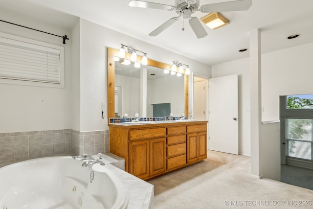 bathroom with a sink, a whirlpool tub, a ceiling fan, and double vanity