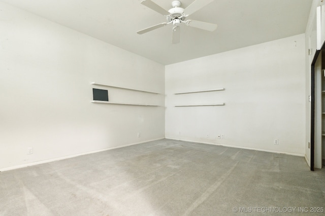 empty room with carpet floors, a ceiling fan, baseboards, and lofted ceiling