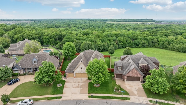 drone / aerial view with a wooded view