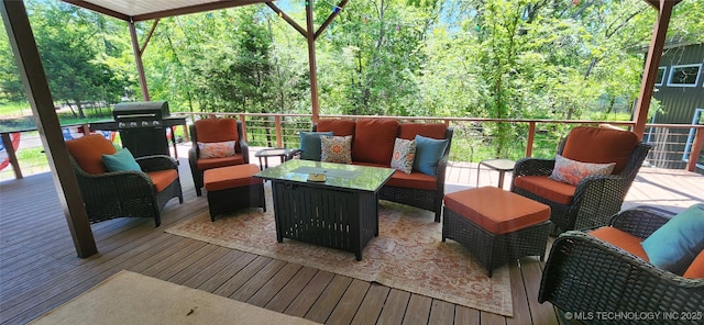 wooden deck featuring outdoor lounge area and a grill