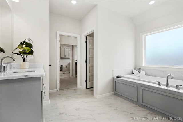 15916 E 106th Pl, Owasso, OK 74055 - bathroom with a garden tub, marble finish floor, baseboards, and recessed lighting
