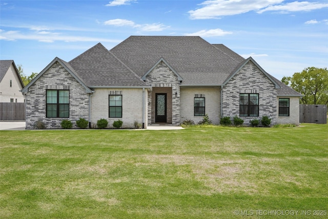 15916 E 106th Pl, Owasso, OK 74055 - view of front facade with fence, a shingled roof, brick siding, and a front yard