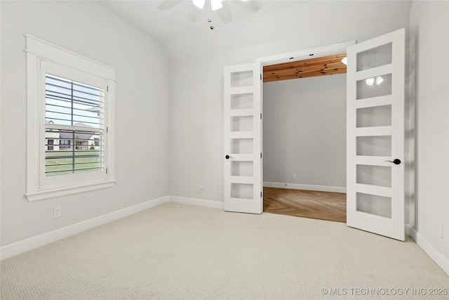 15916 E 106th Pl, Owasso, OK 74055 - unfurnished bedroom with lofted ceiling, french doors, carpet, ceiling fan, and baseboards