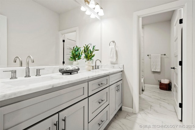 15916 E 106th Pl, Owasso, OK 74055 - bathroom with double vanity, marble finish floor, baseboards, and a sink