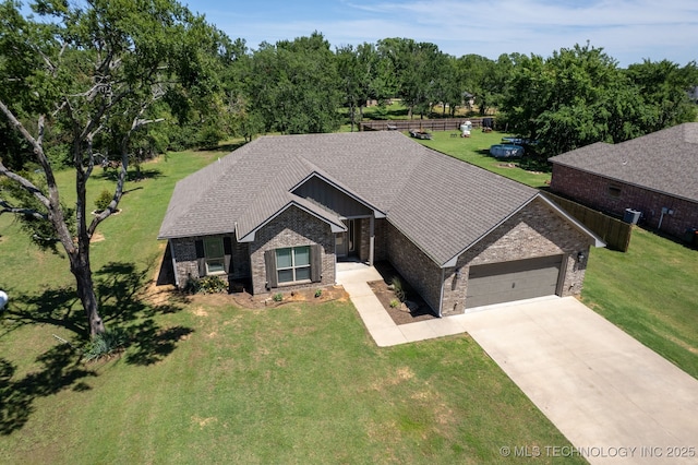 543 Edgewood, Durant, OK 74701 - view of front of property featuring an attached garage, driveway, a front yard, brick siding, and stone siding