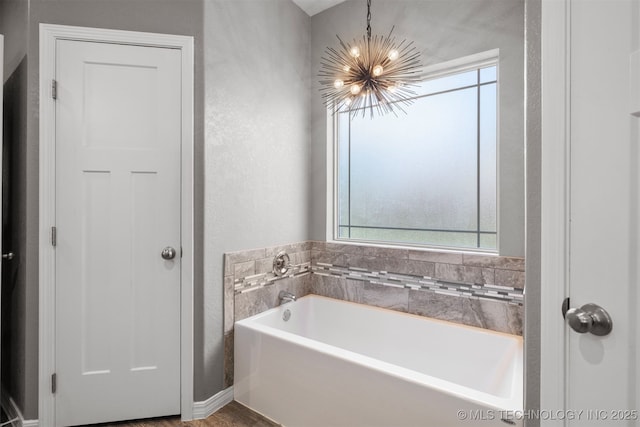 543 Edgewood, Durant, OK 74701 - full bath featuring a chandelier, a bath, and a textured wall