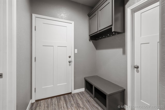 543 Edgewood, Durant, OK 74701 - mudroom featuring wood finished floors, baseboards, and a textured wall