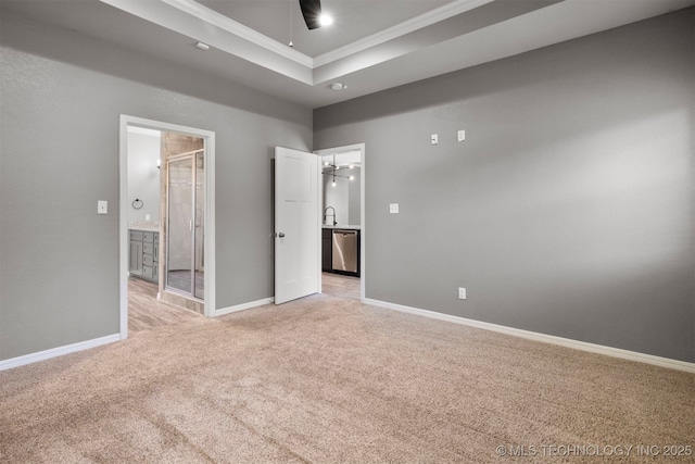 543 Edgewood, Durant, OK 74701 - unfurnished bedroom featuring light colored carpet, ornamental molding, baseboards, ensuite bathroom, and a raised ceiling