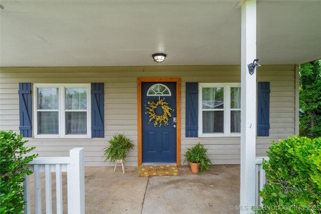 view of exterior entry featuring a porch