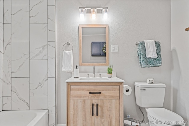 bathroom with toilet, tub / shower combination, and vanity