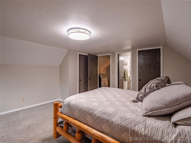 bedroom featuring carpet floors, baseboards, and vaulted ceiling
